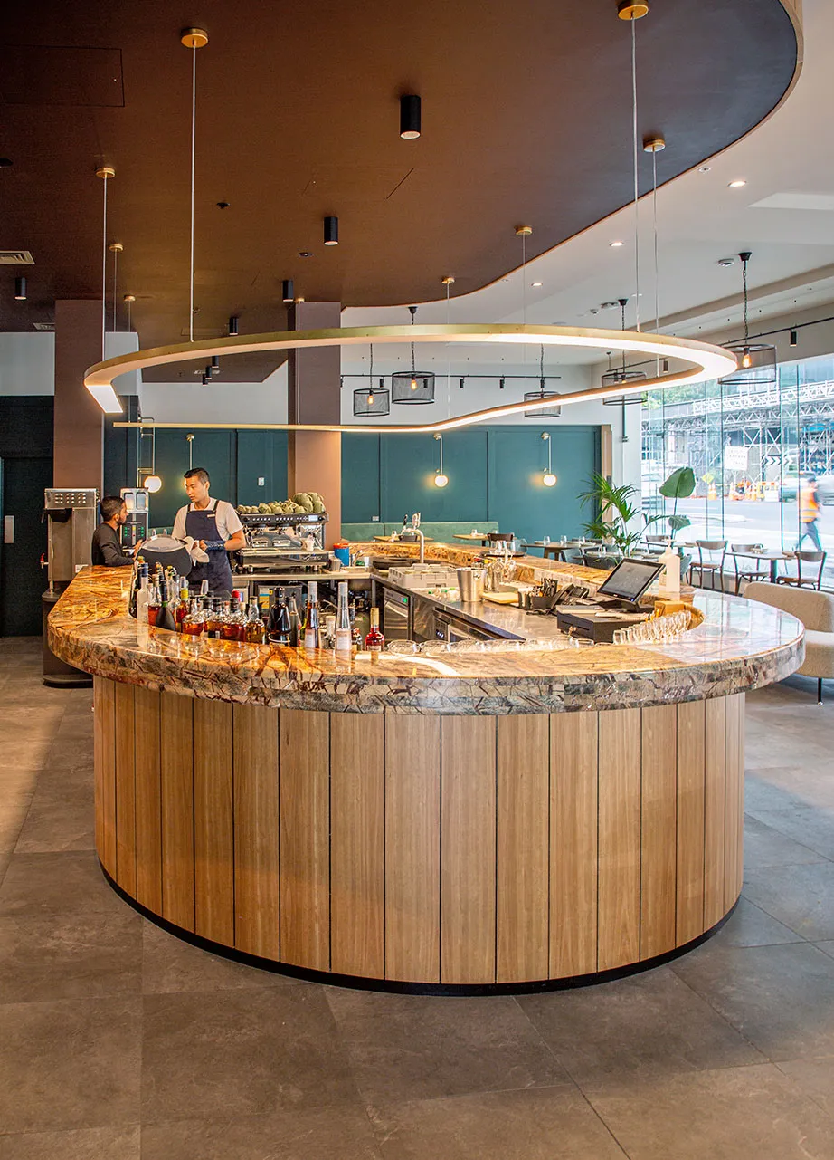 Sudima Hotel bar with timber-clad servery and marble benchtop, Auckland